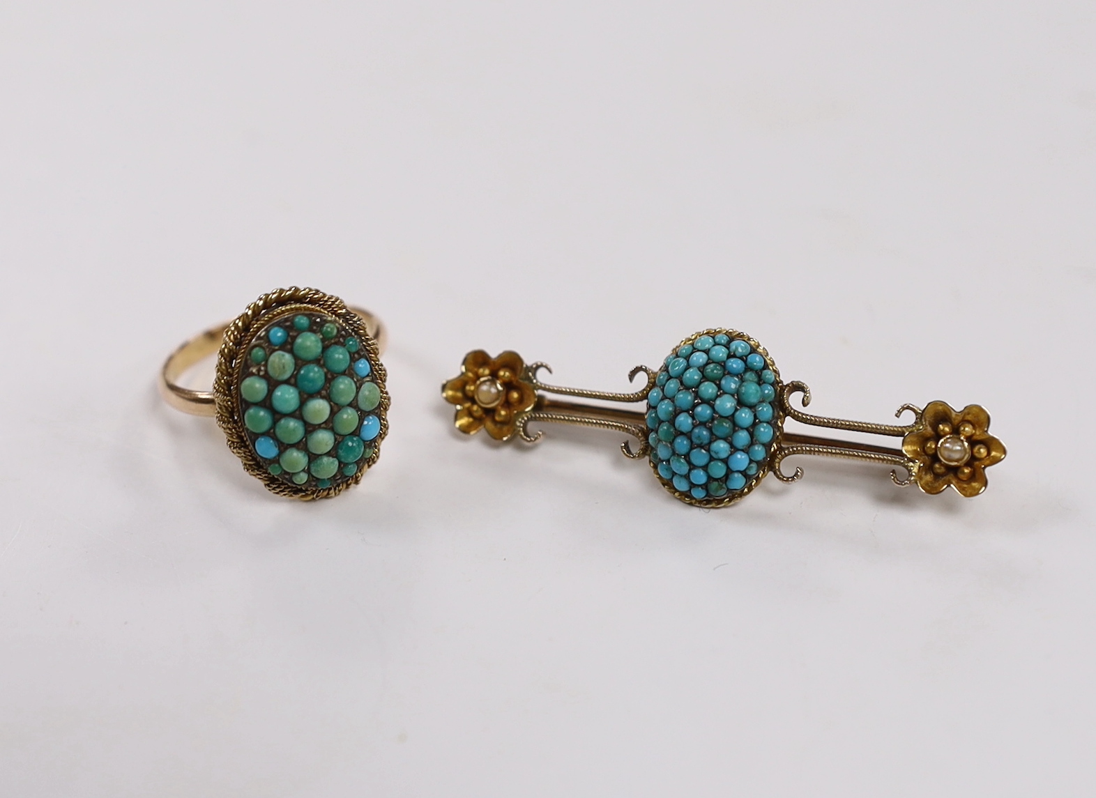 A Victorian 9ct and oval turquoise cluster set dress ring, size P and a similar yellow metal and turquoise set bar brooch, gross weight 9.7 grams.